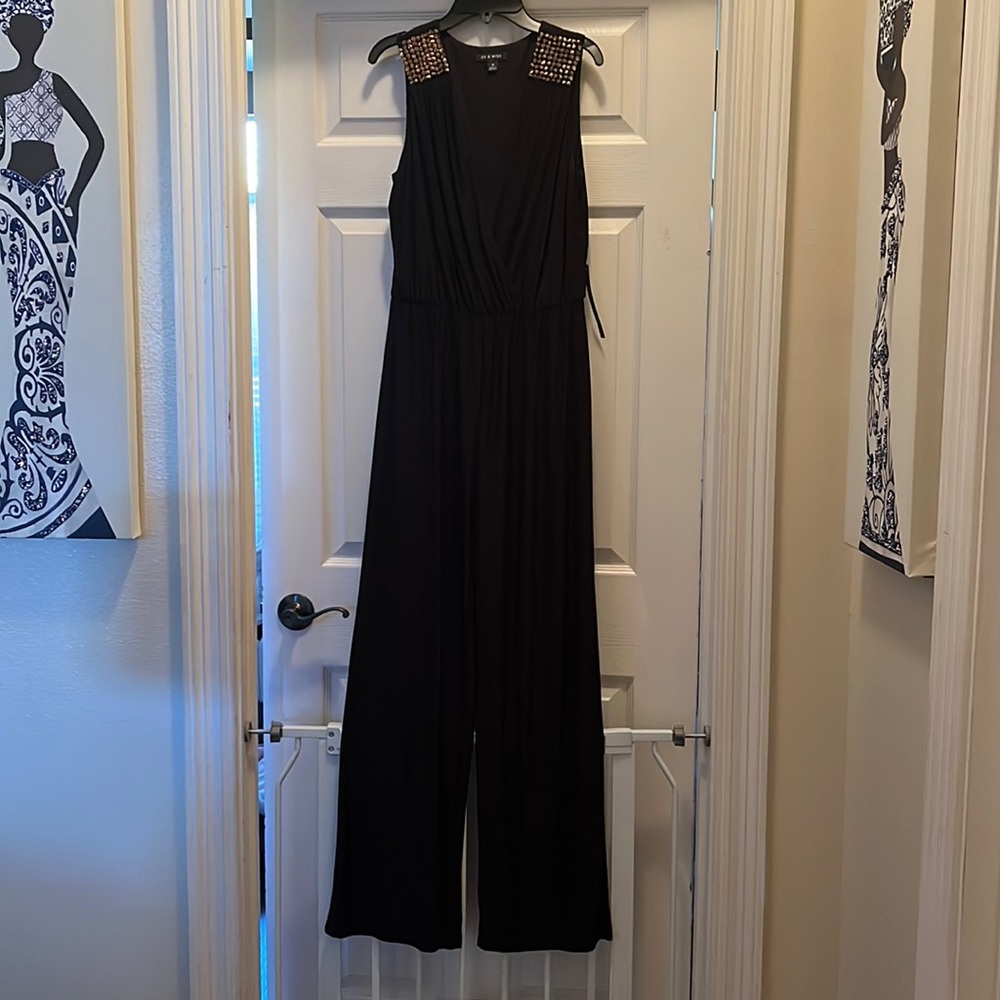As U Wish black medium jumpsuit with wide legs. Gold shoulder details.